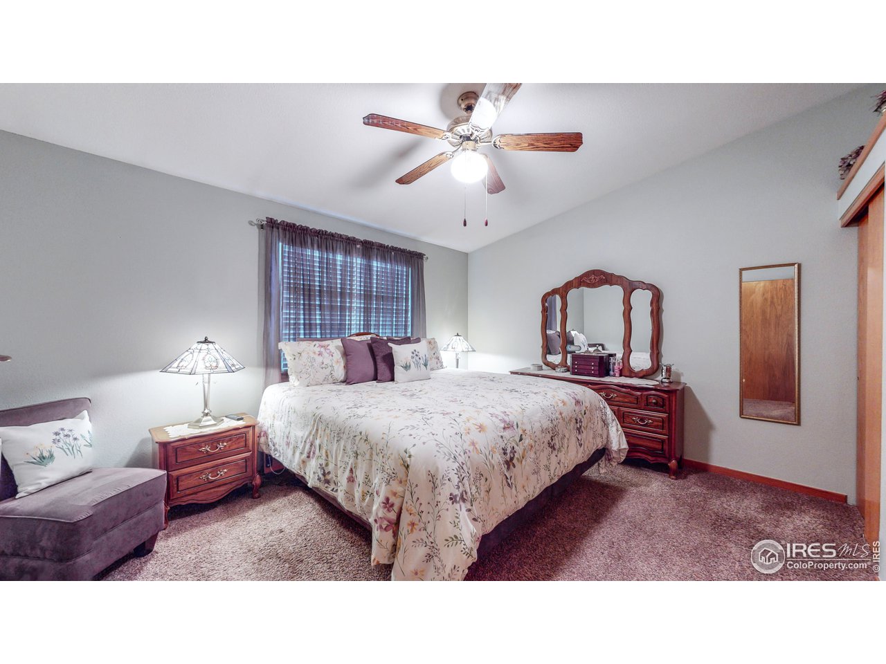 1554 Ervine Avenue Longmont, CO 80501 - Photo 14 of 31 a bed room with a bed and a chandelier
