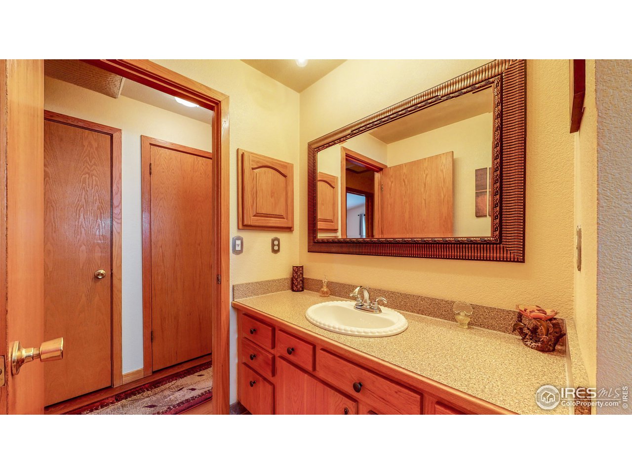 1554 Ervine Avenue Longmont, CO 80501 - Photo 15 of 31 a bathroom with a sink double vanity and a mirror