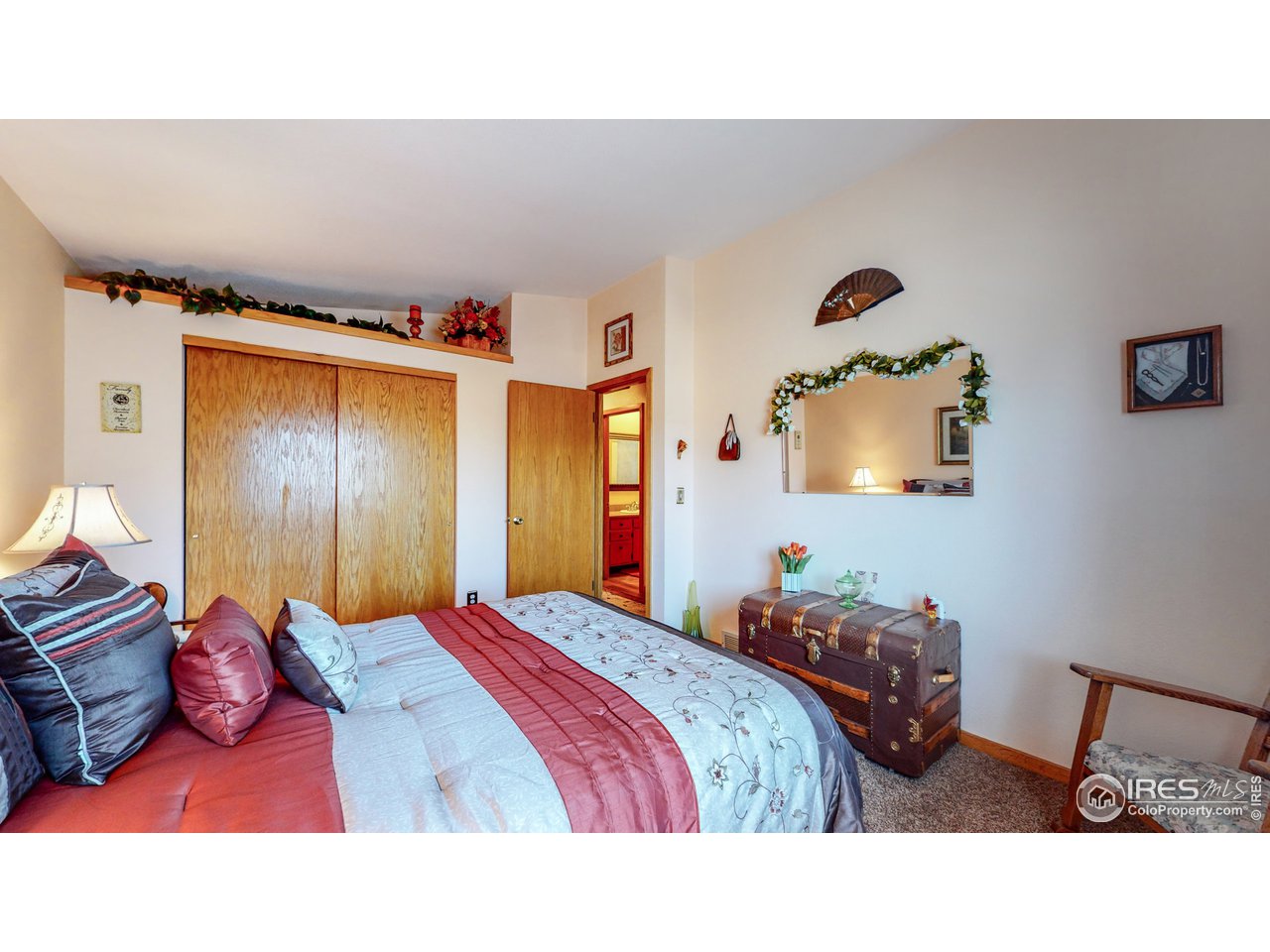 1554 Ervine Avenue Longmont, CO 80501 - Photo 17 of 31 a bedroom with a bed and a painting on the wall