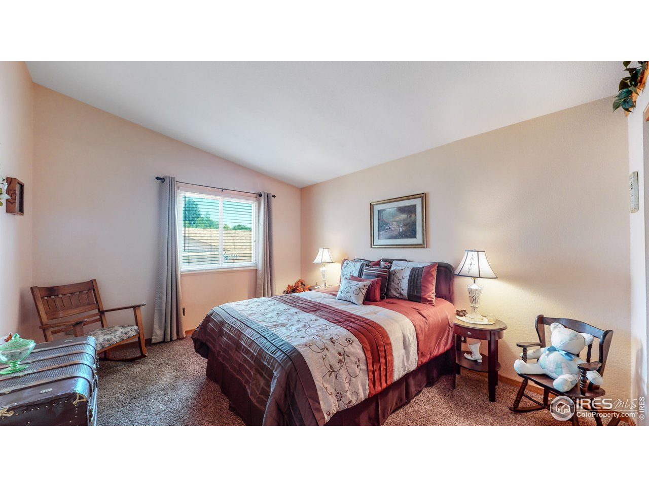 1554 Ervine Avenue Longmont, CO 80501 - Photo 18 of 31 a living room with a bed furniture and a window