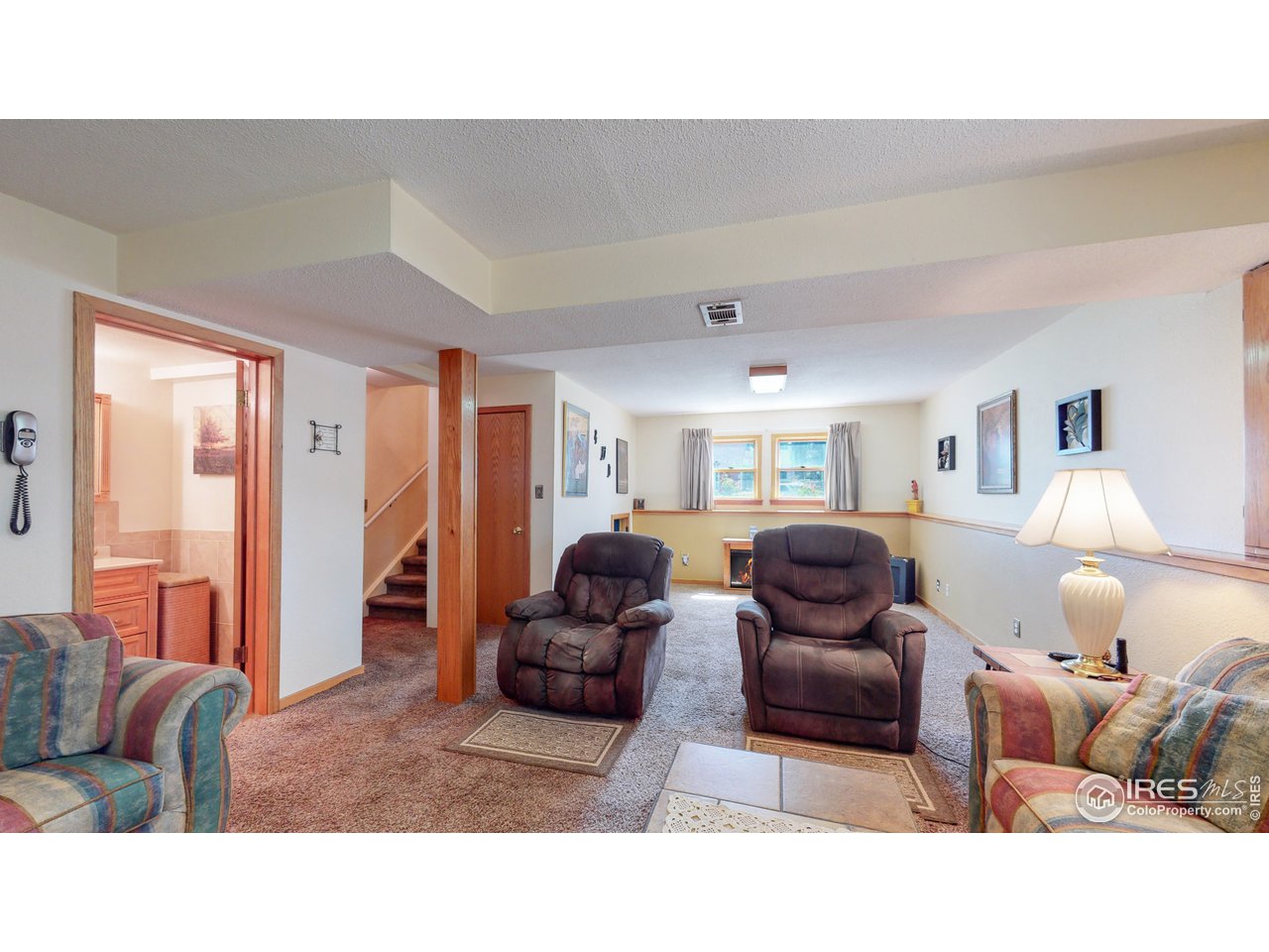 1554 Ervine Avenue Longmont, CO 80501 - Photo 19 of 31 a living room with furniture and a window