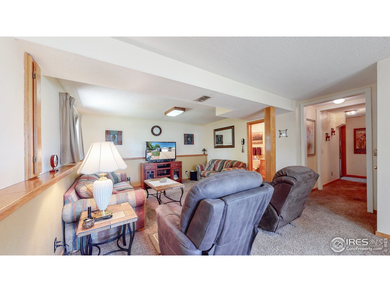 1554 Ervine Avenue Longmont, CO 80501 - Photo 20 of 31 a living room with furniture a wooden floor and next to a window