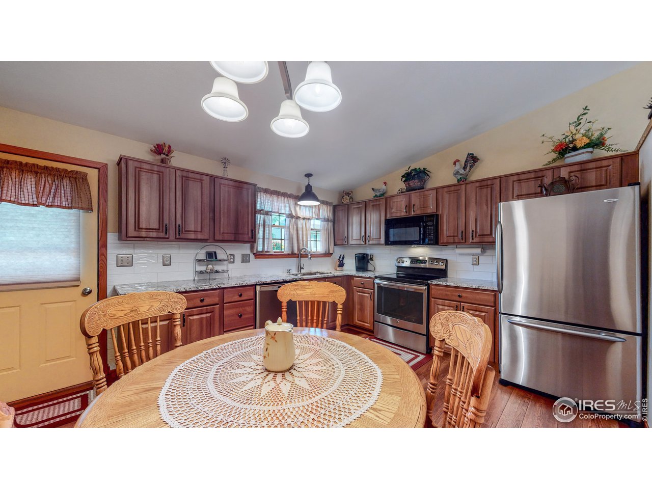 1554 Ervine Avenue Longmont, CO 80501 - Photo 9 of 31 a kitchen with stainless steel appliances granite countertop a sink refrigerator and microwave