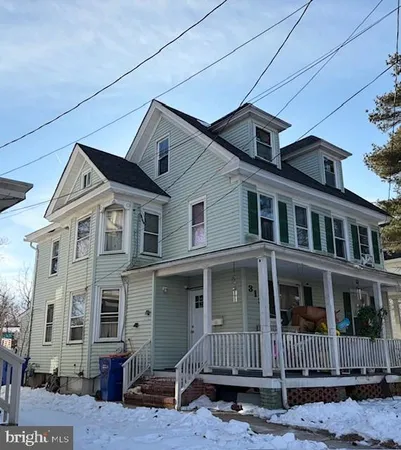 a front view of a house with iron fence
