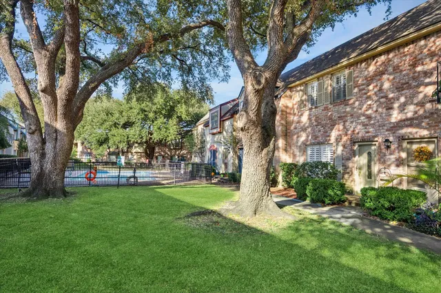 a view of a park with large trees