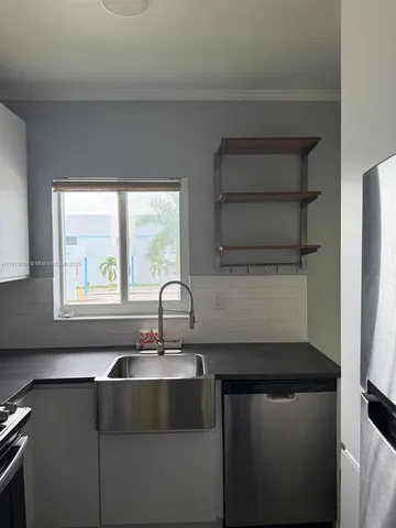 a kitchen with a sink and a window