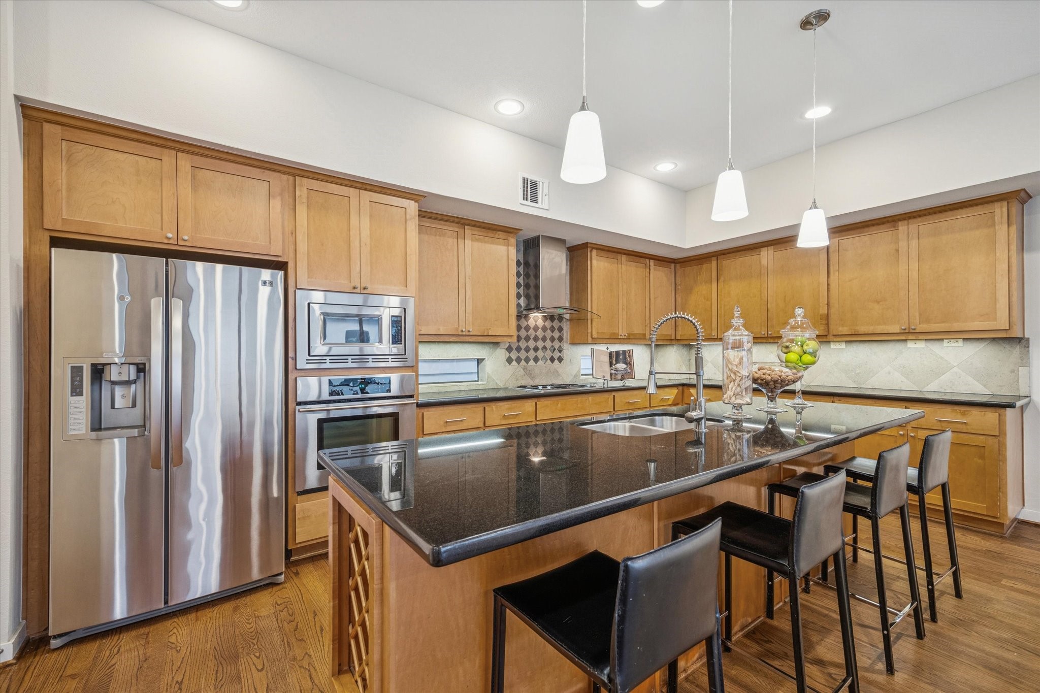 220 Detering Street Houston, TX 77007 - Photo 10 of 27 a kitchen with stainless steel appliances granite countertop a sink refrigerator and cabinets