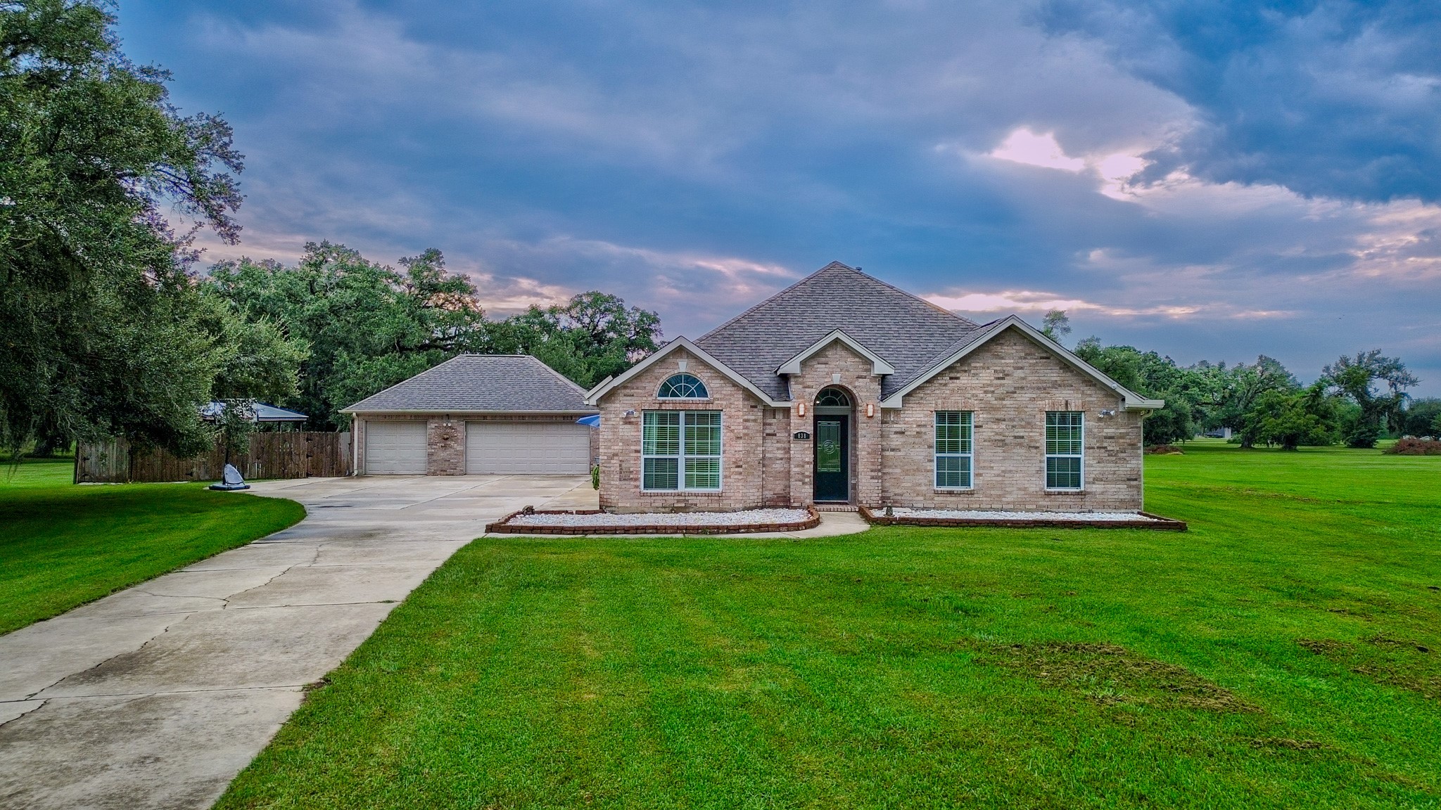 a front view of a house with a yard and trees