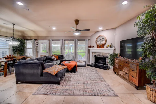 a living room with furniture a fireplace and a flat screen tv