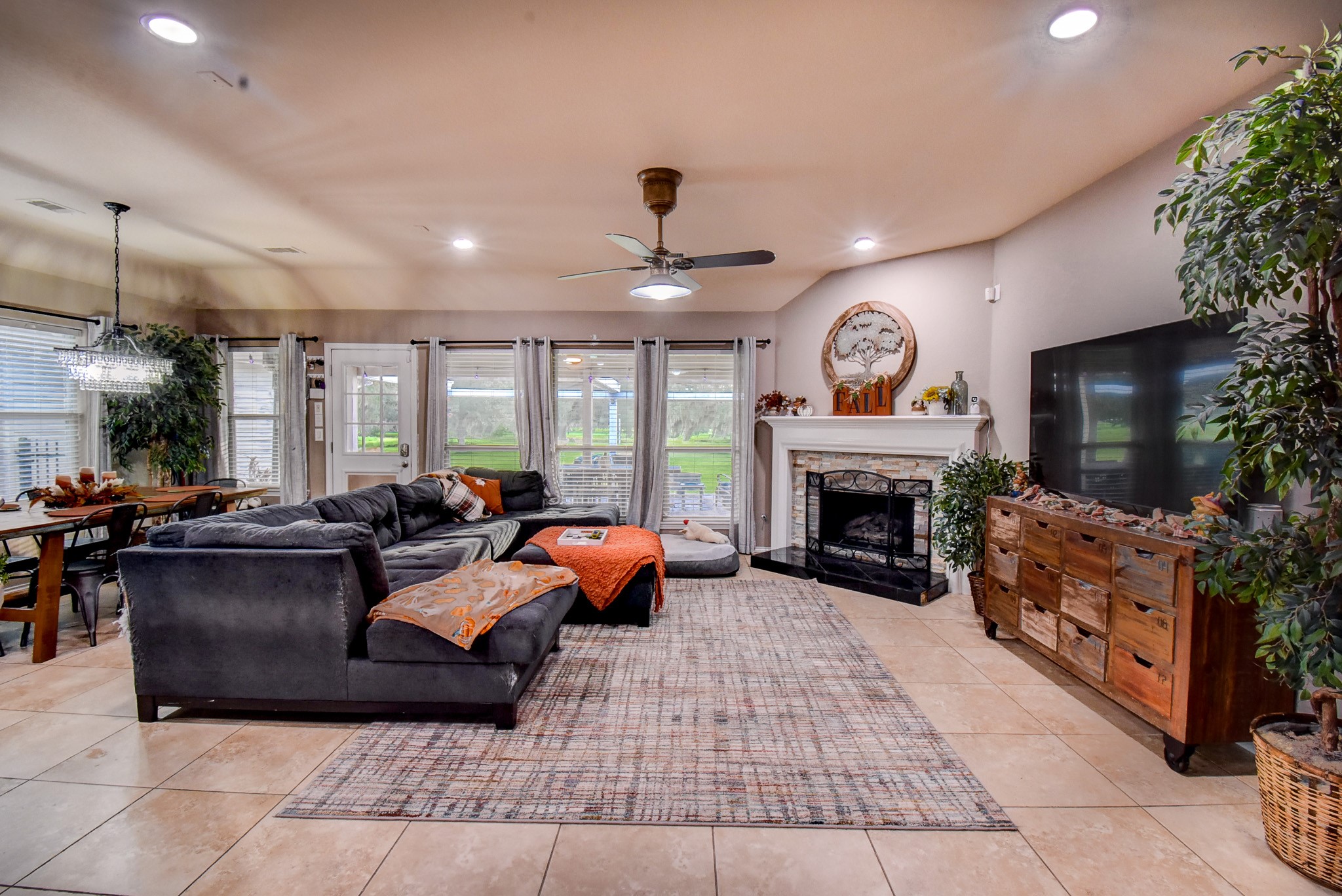 838 County Road 968 A Angleton, TX 77515 - Photo 11 of 49 a living room with furniture a fireplace and a flat screen tv