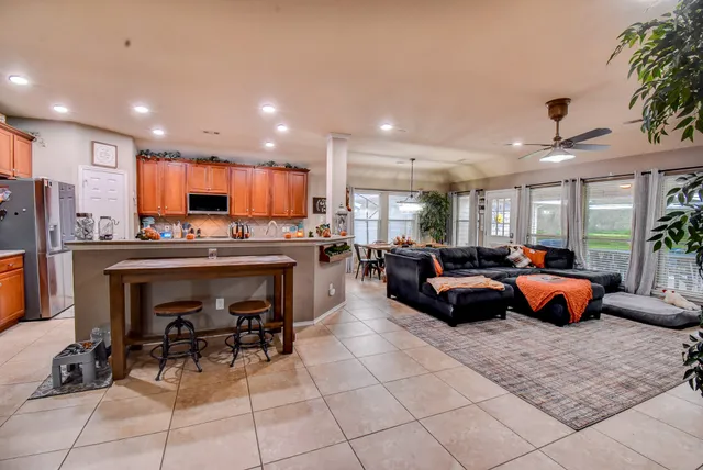 a large kitchen with a table and chairs