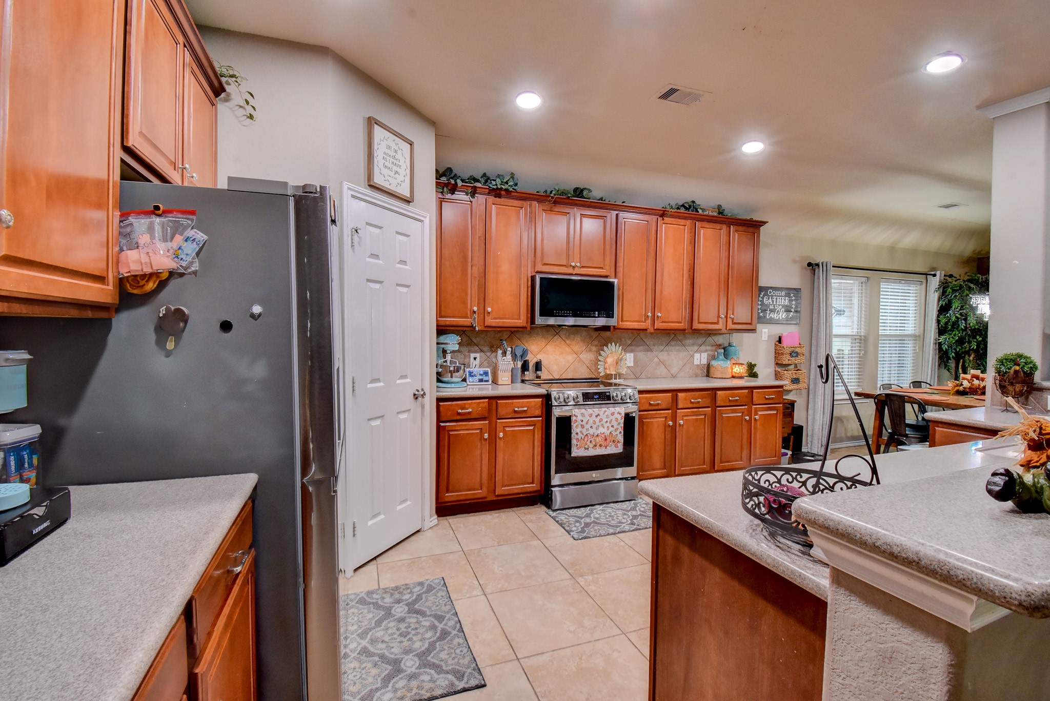 838 County Road 968 A Angleton, TX 77515 - Photo 14 of 49 a kitchen with stainless steel appliances granite countertop a sink stove and refrigerator