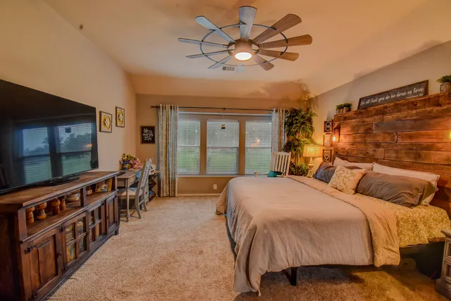 a bed room with a bed and a large window