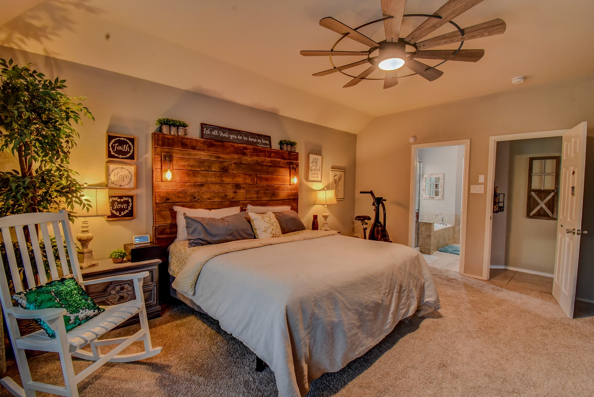 838 County Road 968 A Angleton, TX 77515 - Photo 21 of 49 a spacious bedroom with a bed and a chandelier