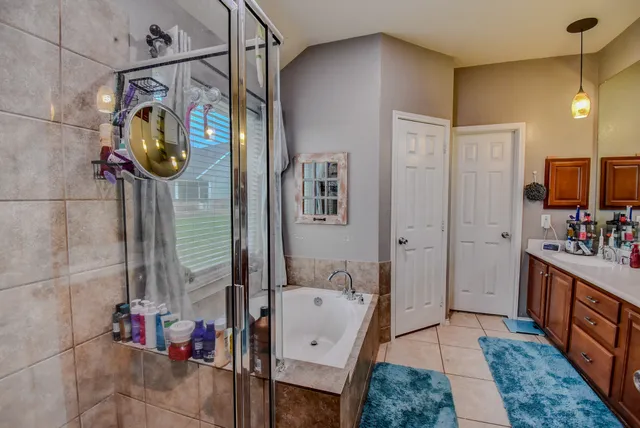 a bathroom with a tub sink and mirror