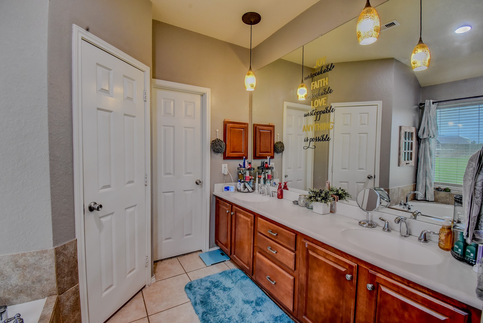 838 County Road 968 A Angleton, TX 77515 - Photo 23 of 49 a bathroom with a double vanity sink and a mirror