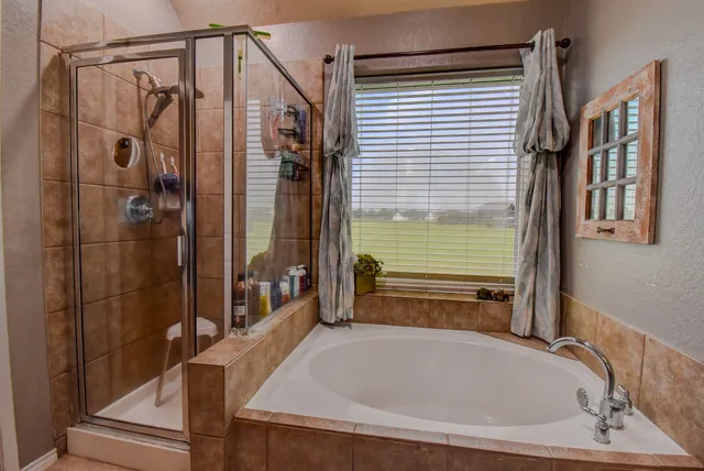 a bathroom with a tub and shower