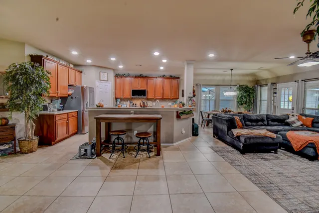 a living room with furniture and kitchen view