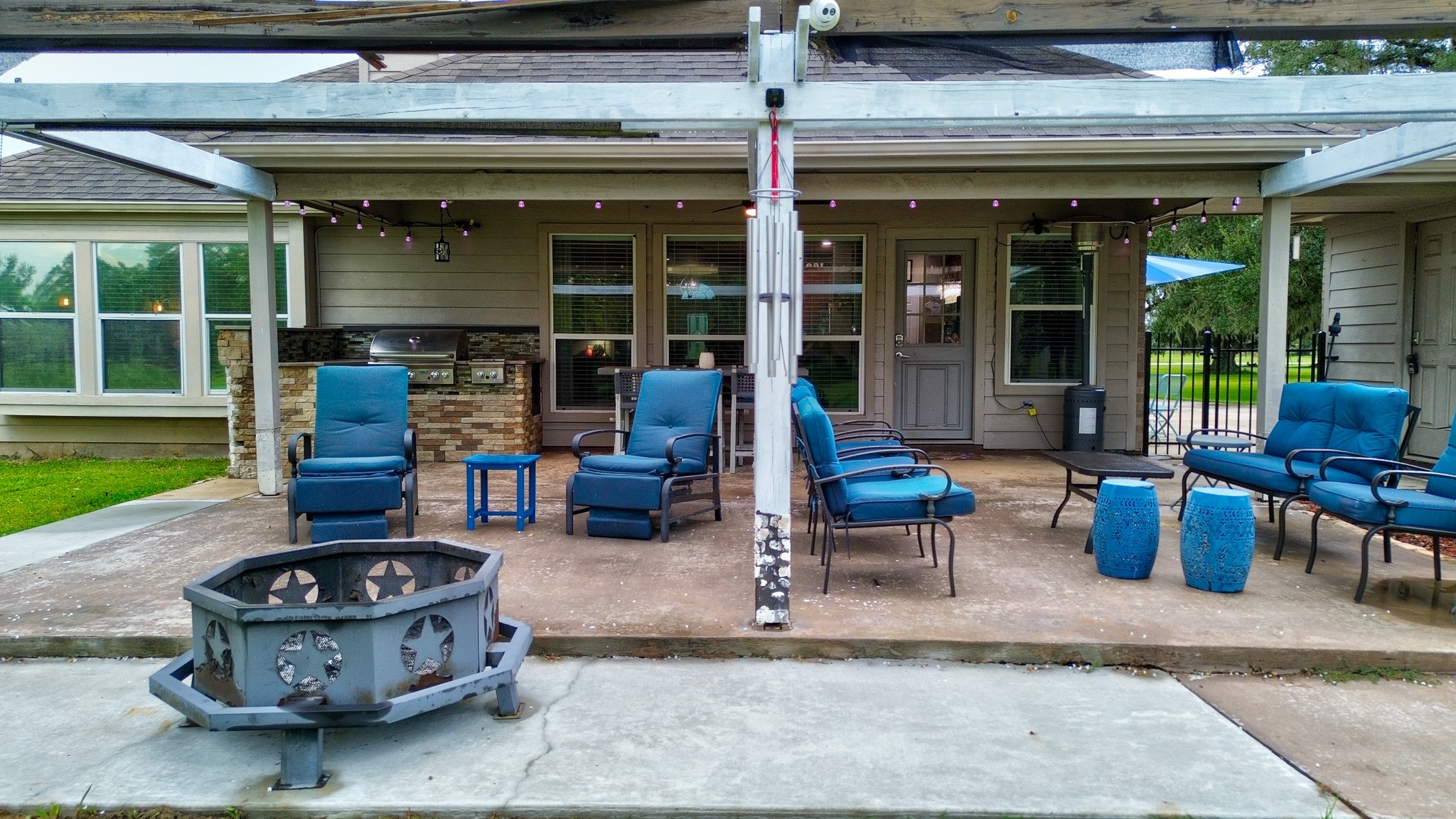 838 County Road 968 A Angleton, TX 77515 - Photo 44 of 49 a view of a patio with table and chairs potted plants and floor to ceiling window