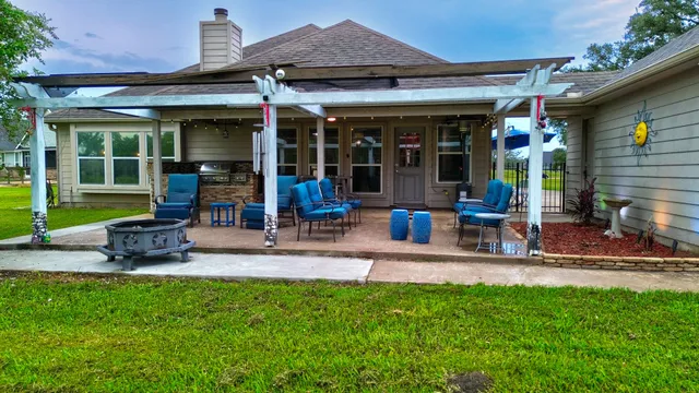 a view of a patio with a table and chairs under an umbrella