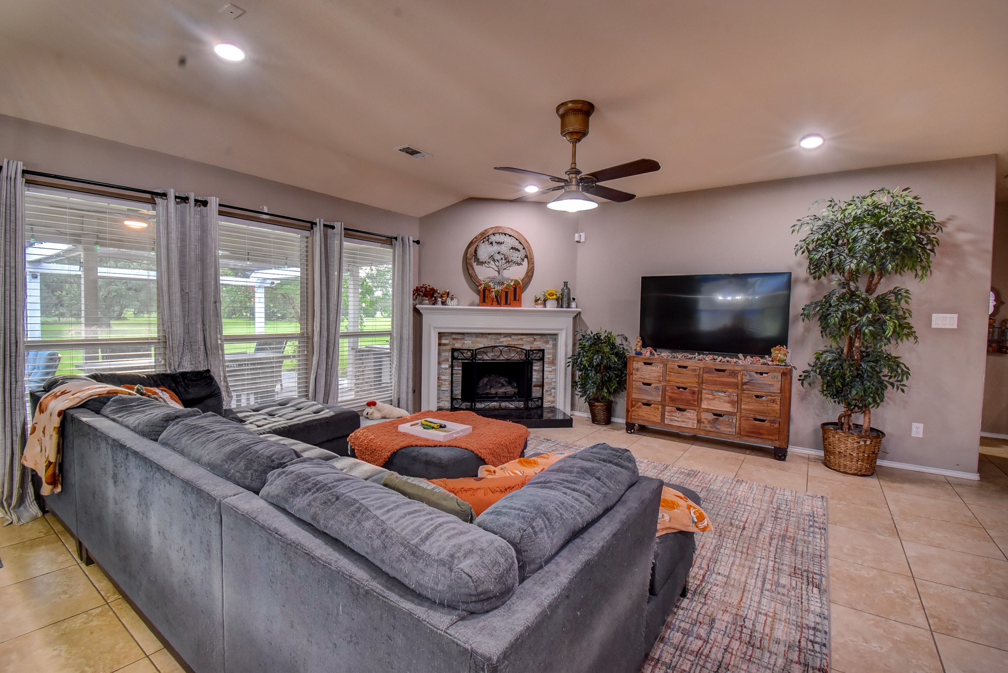 838 County Road 968 A Angleton, TX 77515 - Photo 10 of 49 a living room with furniture a flat screen tv and a fireplace