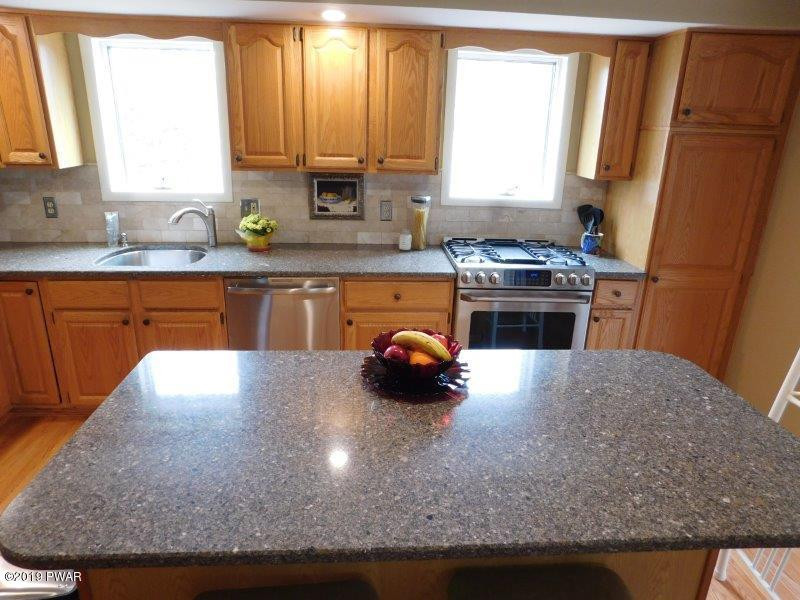 102 Rodeo Lane Hawley, PA 18428 - Photo 13 of 52 a kitchen with stainless steel appliances granite countertop a sink stove and refrigerator
