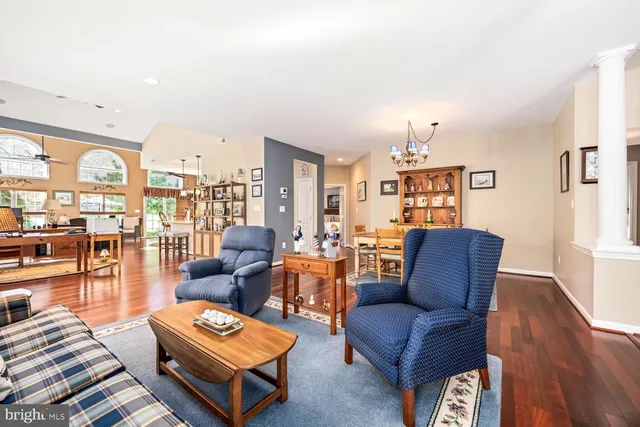 a living room with furniture a rug and a floor to ceiling window