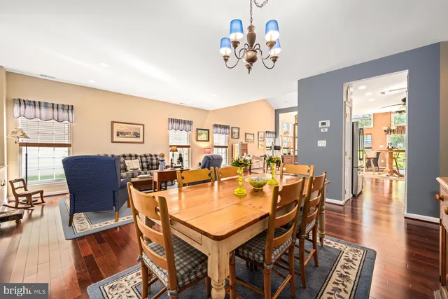 a view of a dining room with furniture wooden floor and chandelier