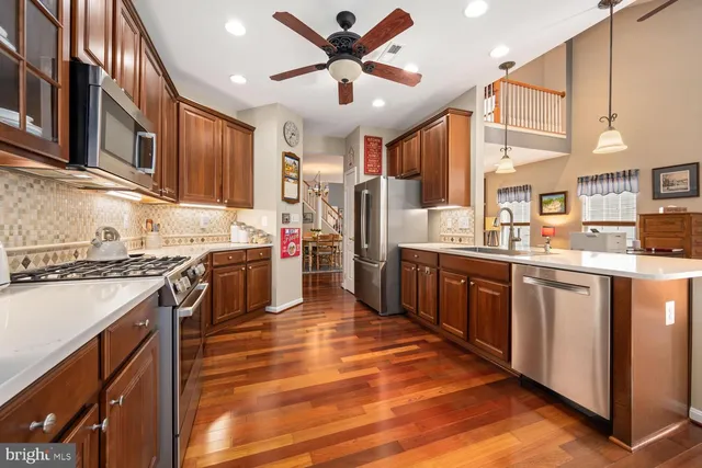 a kitchen with stainless steel appliances granite countertop a stove and a sink