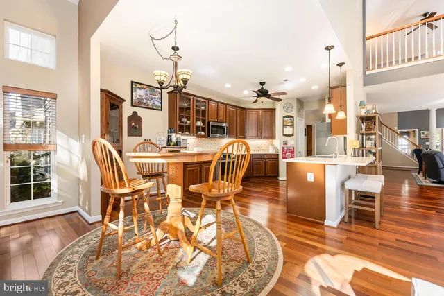 a dining room with furniture a chandelier and wooden floor