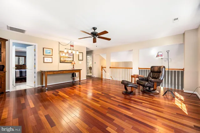 a living room with furniture a fireplace and wooden floor