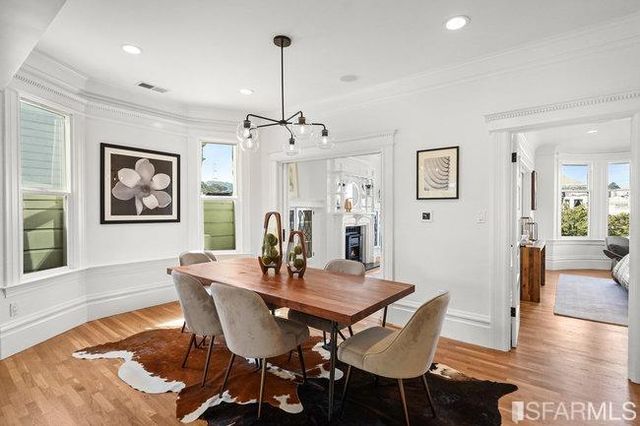a view of a dining room with furniture window and wooden floor