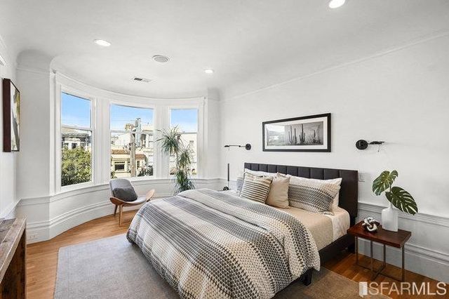 a bedroom with a bed and a fireplace