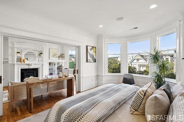 a bedroom with bed and night stand