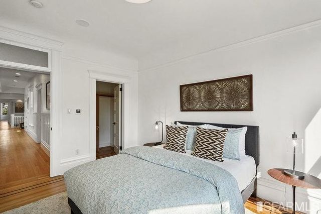 a view of living room with large windows and flower plants