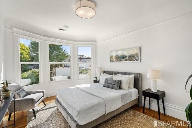 a bedroom with bed and a potted plant