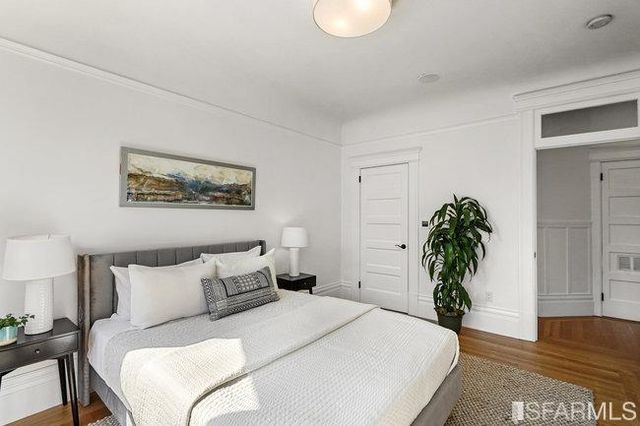 a bedroom with furniture and a flat screen tv