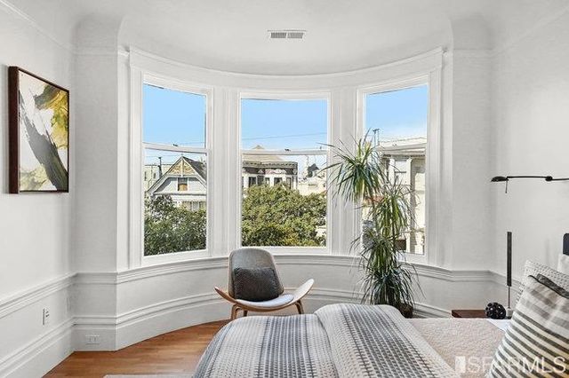 a bedroom with a large bed and a balcony