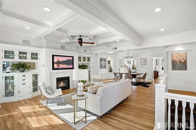 a living room with furniture flowerpot and a chandelier