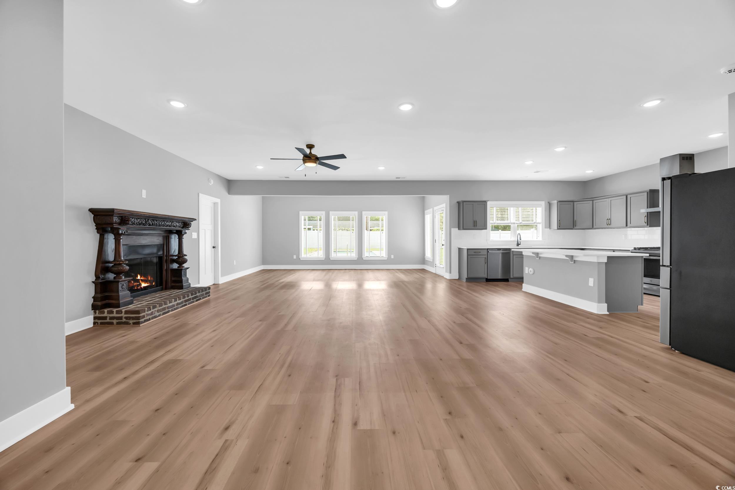 1121 Grimes Street Georgetown, SC 29440 - Photo 13 of 27 Kitchen with gray cabinetry, gas stove, wall chimney range hood, decorative backsplash, and recessed lighting