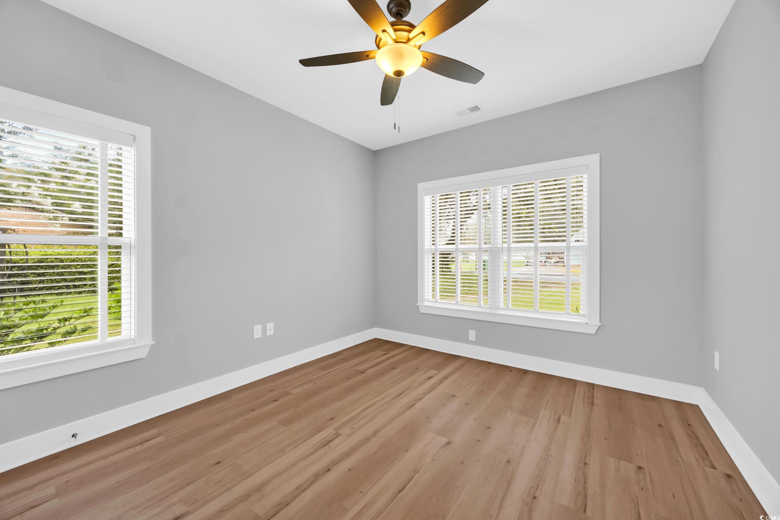 1121 Grimes Street Georgetown, SC 29440 - Photo 18 of 27 Full bath featuring healthy amount of natural light, washtub / shower combination, and wood finished floors