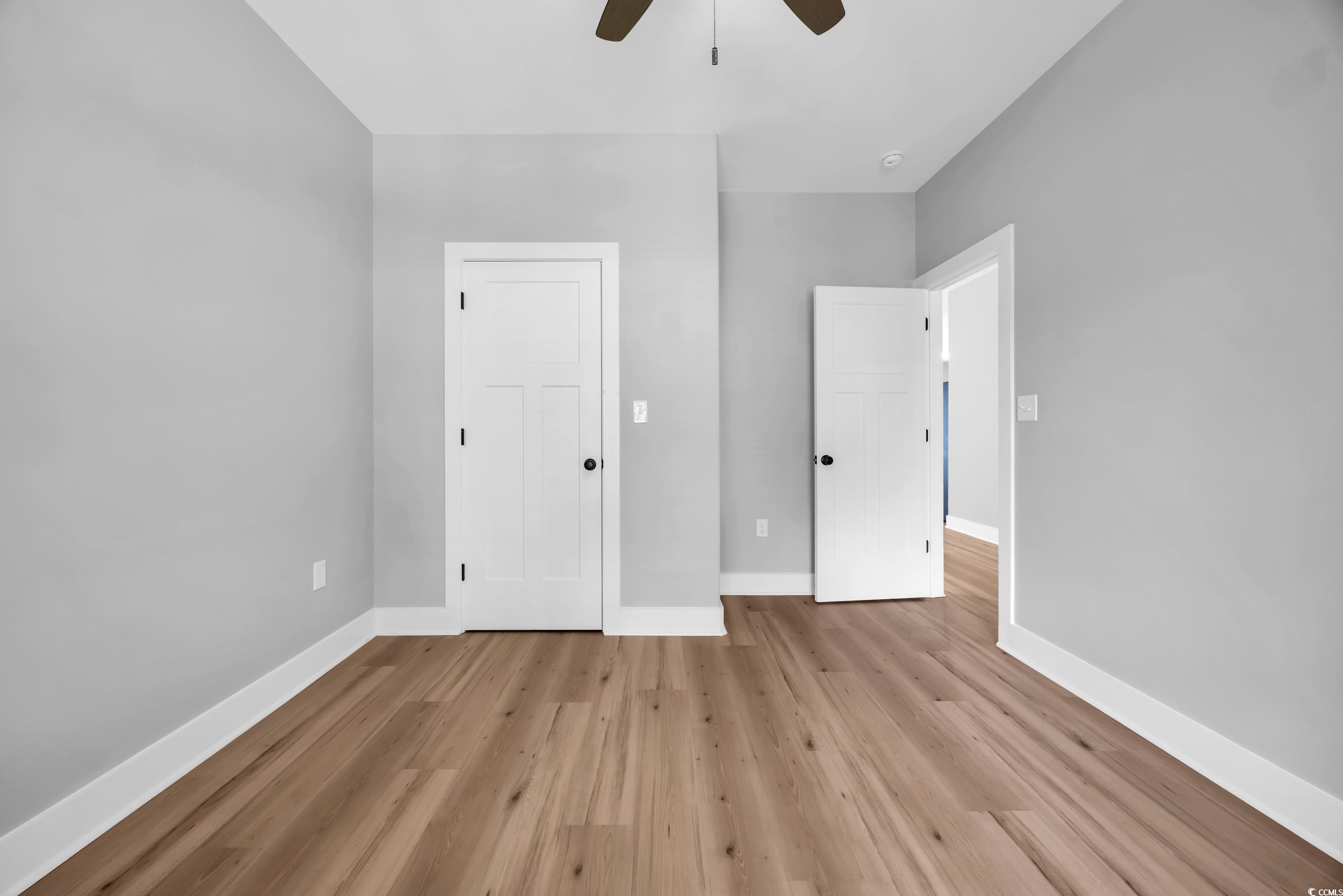 1121 Grimes Street Georgetown, SC 29440 - Photo 20 of 27 Empty room with plenty of natural light, wood finished floors, and a ceiling fan