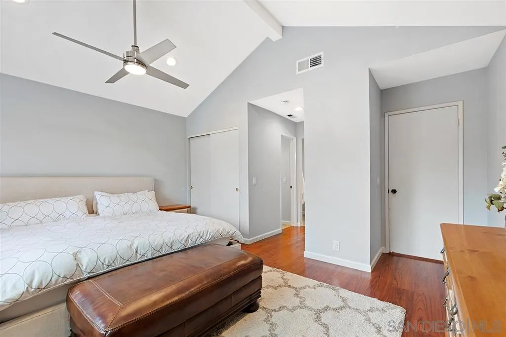 5673 Raintree Way Oceanside, CA 92057 - Photo 11 of 23 a bedroom with a bed and wooden floor