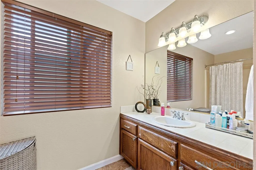 5673 Raintree Way Oceanside, CA 92057 - Photo 12 of 23 a bathroom with a sink and a mirror