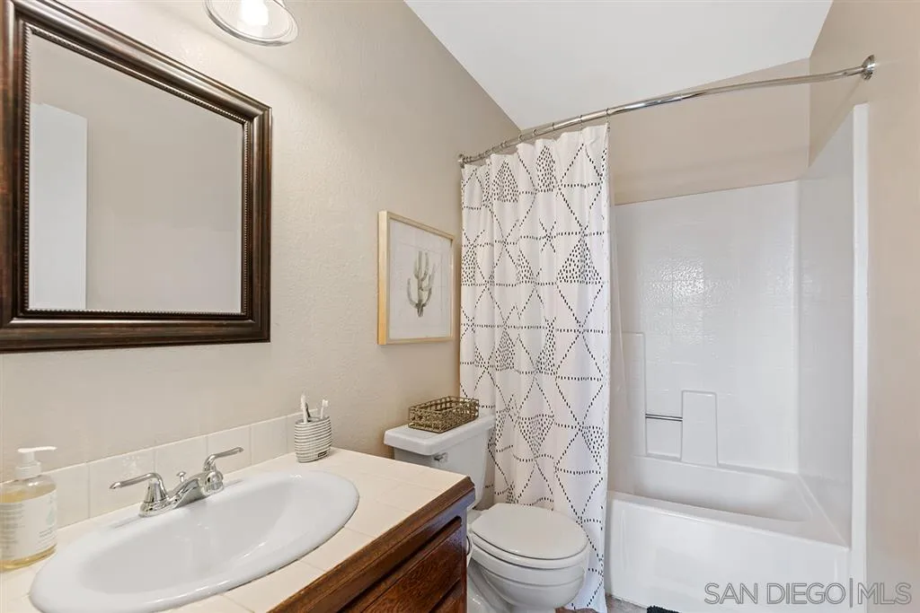5673 Raintree Way Oceanside, CA 92057 - Photo 15 of 23 a bathroom with a sink toilet and shower
