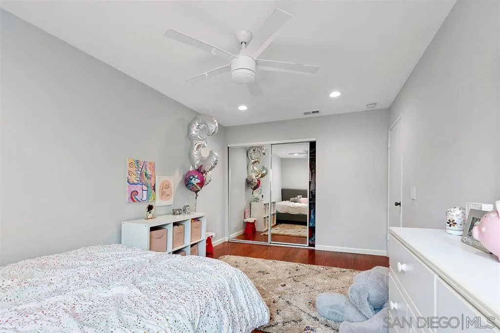 5673 Raintree Way Oceanside, CA 92057 - Photo 17 of 23 a bedroom with a bed and a dresser