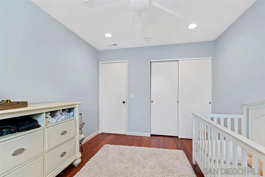 5673 Raintree Way Oceanside, CA 92057 - Photo 19 of 23 a view of an empty room with closet and wooden floor
