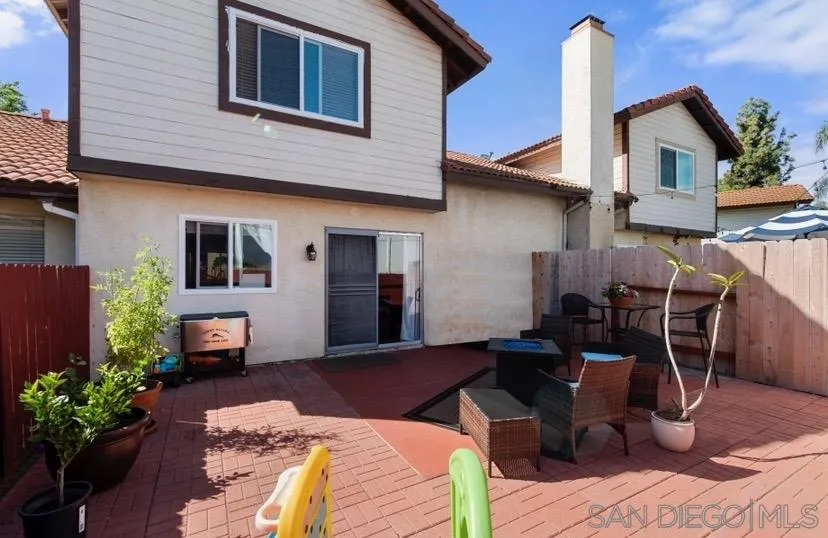 5673 Raintree Way Oceanside, CA 92057 - Photo 21 of 23 a view of a patio with couches chairs potted plants and wooden floor