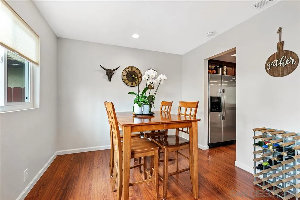 5673 Raintree Way Oceanside, CA 92057 - Photo 7 of 23 a view of a dining room with furniture and wooden floor