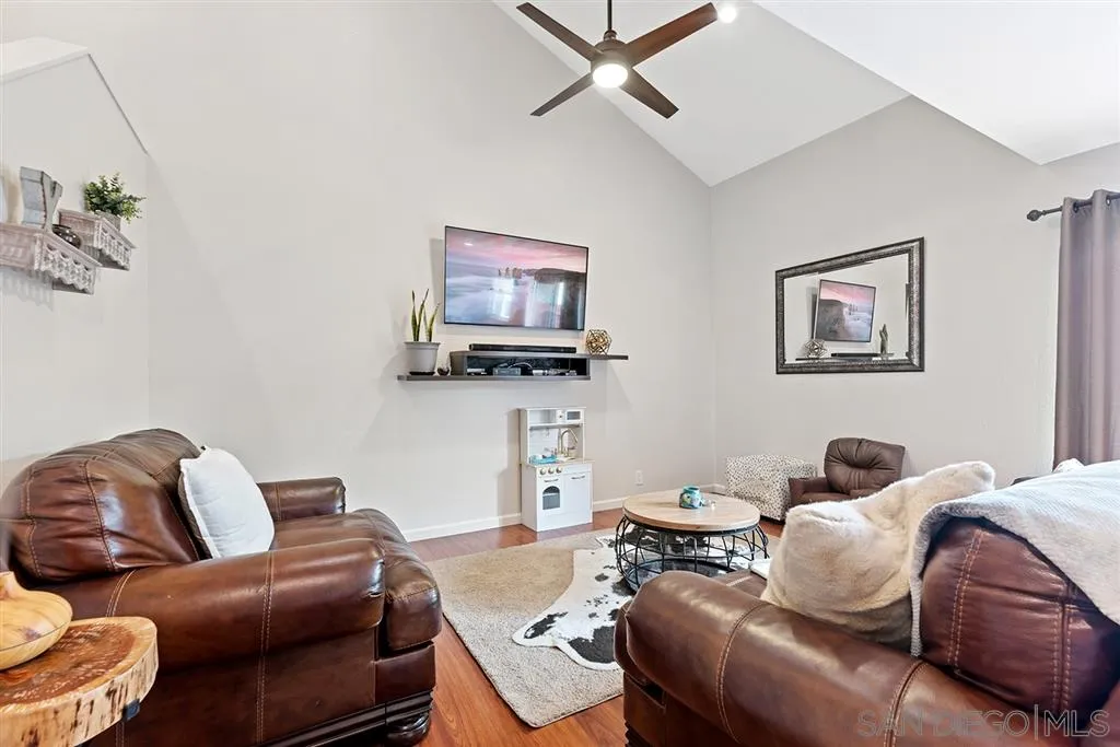 5673 Raintree Way Oceanside, CA 92057 - Photo 8 of 23 a living room with furniture and a flat screen tv